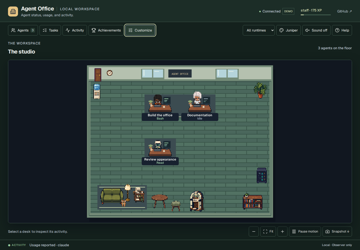 Agent Office in the green Juniper theme, with people and a robot at walnut desks, a lounge, and room controls.